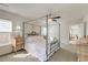 Sunlit bedroom featuring a canopy bed, ceiling fan, and soft natural light through the windows at 7034 Lanier St, Hanahan, SC 29410