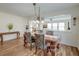 Elegant dining room with hardwood floors, stylish chandelier, and ample natural light at 7034 Lanier St, Hanahan, SC 29410