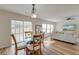 Bright dining area featuring a glass table, hardwood floors, and open access to the living room at 7034 Lanier St, Hanahan, SC 29410