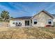 Back exterior featuring sliding glass doors, patio, and manicured lawn at 7034 Lanier St, Hanahan, SC 29410