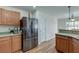 Modern kitchen featuring wood cabinets, a stainless steel refrigerator, and ample counter space at 7034 Lanier St, Hanahan, SC 29410