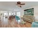 Spacious living room with a dining area, featuring hardwood floors, a ceiling fan, and an abundance of natural light at 7034 Lanier St, Hanahan, SC 29410