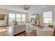 Bright living room with a large window, stylish furnishings, and hardwood floors under a decorative rug at 7034 Lanier St, Hanahan, SC 29410