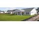 Well-manicured backyard featuring a covered patio on a house with white siding and black roof at 143 Summerwind Dr, Summerville, SC 29486