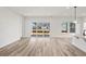 Open-concept room with light wood floors, recessed lighting, and a sliding glass door to the backyard at 143 Summerwind Dr, Summerville, SC 29486