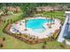 Community pool with plenty of lounge chairs and umbrellas at 1639 Cultivation Ln # 449, Mount Pleasant, SC 29466