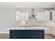 White kitchen cabinets, a large island, and stainless steel appliances at 1639 Cultivation Ln # 449, Mount Pleasant, SC 29466