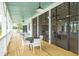 Relaxing screened porch with wooden floors and white furniture at 1639 Cultivation Ln # 449, Mount Pleasant, SC 29466