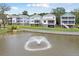 Aerial view of houses with a pond and fountain in Liberty Hill Farm at 1686 Cultivation Ln # 544, Mount Pleasant, SC 29466