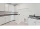 Laundry room with white cabinets, granite counters, and a utility sink at 1686 Cultivation Ln # 544, Mount Pleasant, SC 29466