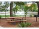 Relaxing picnic area with table, benches, and grill by a pond at 1686 Cultivation Ln # 544, Mount Pleasant, SC 29466