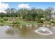 Peaceful pond with fountain, landscaping, and community in background at 1686 Cultivation Ln # 544, Mount Pleasant, SC 29466