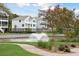 Quaint pond with fountain, landscaping, and homes in the background at 1686 Cultivation Ln # 544, Mount Pleasant, SC 29466