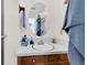 Bathroom with oval mirror and wooden vanity at 13 Charlyn Dr, Charleston, SC 29407