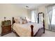 Bedroom with wooden bed frame, neutral decor, and ample natural light at 13 Charlyn Dr, Charleston, SC 29407