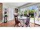 Dining area with hardwood floors, round table, and view of backyard at 13 Charlyn Dr, Charleston, SC 29407