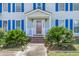 Front entrance with white columns, brick steps, and lush landscaping at 13 Charlyn Dr, Charleston, SC 29407