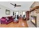 Living room with brick fireplace, hardwood floors, and a ceiling fan at 13 Charlyn Dr, Charleston, SC 29407