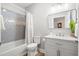 Neutral bathroom featuring a shower-tub combo with modern tile and vanity with recessed lighting and large mirror at 8272 Palmetto Rd, Edisto Island, SC 29438