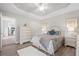 Light-filled bedroom with wood floors, neutral paint, and a view into the modern kitchen at 8272 Palmetto Rd, Edisto Island, SC 29438