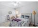 Bright bedroom featuring a stylish bed, chair, and a large window for natural light at 8272 Palmetto Rd, Edisto Island, SC 29438