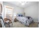 Bright bedroom featuring a stylish bed, chair, and a large window for natural light at 8272 Palmetto Rd, Edisto Island, SC 29438