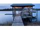 Covered boat dock with boat lift on the water, ready for boating adventures at 8272 Palmetto Rd, Edisto Island, SC 29438