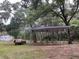 View of a carport on a wooded lot, offering parking and storage at 8272 Palmetto Rd, Edisto Island, SC 29438