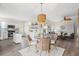 Dining area with a glass table and wicker chairs, flowing into a bright and open living space at 8272 Palmetto Rd, Edisto Island, SC 29438