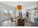 Bright dining area with hardwood floors, natural light, and stylish wicker chairs at 8272 Palmetto Rd, Edisto Island, SC 29438