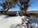 Scenic view of a snow covered path leading to a marsh and home with an old chair in the foreground at 8272 Palmetto Rd, Edisto Island, SC 29438