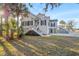 Charming two-story traditional home with a white exterior, black shutters, and a grand staircase at 8272 Palmetto Rd, Edisto Island, SC 29438