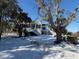 Snow covered home featuring classic architecture, mature trees, offering picturesque winter scene at 8272 Palmetto Rd, Edisto Island, SC 29438