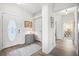 Bright foyer featuring a wood-look floor and a decorative cabinet and lamp at 8272 Palmetto Rd, Edisto Island, SC 29438