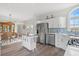 Open kitchen with stainless steel appliances, a central island, and hardwood flooring at 8272 Palmetto Rd, Edisto Island, SC 29438