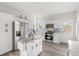 Clean kitchen with stainless steel appliances, white cabinetry, and hardwood floors at 8272 Palmetto Rd, Edisto Island, SC 29438