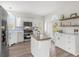 Bright kitchen featuring white cabinetry, stainless steel appliances, and ample counter space at 8272 Palmetto Rd, Edisto Island, SC 29438