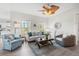 Cozy living room showcasing hardwood floors, comfortable furniture, and a stylish ceiling fan at 8272 Palmetto Rd, Edisto Island, SC 29438