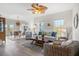 Bright living room featuring hardwood floors, a ceiling fan, and comfortable seating arrangements at 8272 Palmetto Rd, Edisto Island, SC 29438