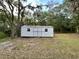 Outbuilding on grassy lot with a storage shed that offers practical utility and storage solutions at 8272 Palmetto Rd, Edisto Island, SC 29438