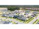 Aerial view of suburban homes, construction, wooded backdrop and homes with back yard pools at 450 Ripple Park Dr, Summerville, SC 29486