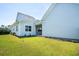 Backyard with a healthy, green lawn, an irrigation system, and neutral-colored siding at 450 Ripple Park Dr, Summerville, SC 29486