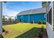 A cozy backyard with an air conditioning unit, partial fence, and healthy, green lawn at 450 Ripple Park Dr, Summerville, SC 29486