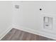 Unfinished basement with wood-look floors, utility hookups, and white trim at 450 Ripple Park Dr, Summerville, SC 29486
