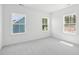Bright, airy bedroom featuring plush carpeting and natural light from three large windows at 450 Ripple Park Dr, Summerville, SC 29486