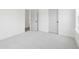 Bright bedroom with neutral carpet, white trim, and two white doors at 450 Ripple Park Dr, Summerville, SC 29486