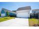 Attached two-car garage with large driveway, well-kept lawn, and mature landscaping at 450 Ripple Park Dr, Summerville, SC 29486