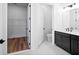 Contemporary bathroom with dark vanity, white marble floors, and a walk-in closet at 133 Summerwind Dr, Summerville, SC 29486