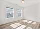 Sun-filled bedroom with light hardwood floors and two windows providing ample natural light at 133 Summerwind Dr, Summerville, SC 29486