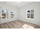 Bright bedroom filled with sunlight streaming through large windows, enhancing the hardwood flooring at 133 Summerwind Dr, Summerville, SC 29486
